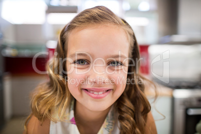 Girl smiling at camera at home
