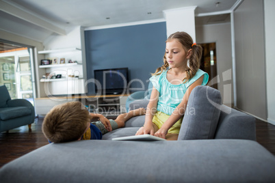 Siblings interacting with each other in living room