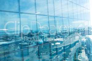 Office building exterior with reflection of city against sky