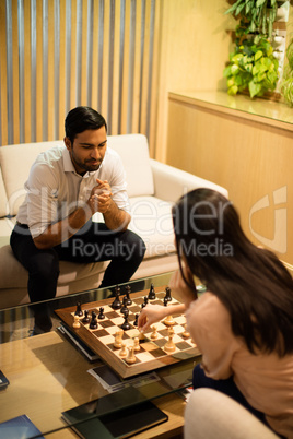 High angle view of business colleagues playing chess