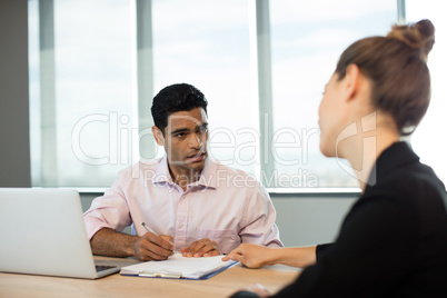 Business people discussing contract during meeting