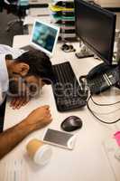 Tired businessman sleeping in office