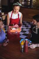 Waitress serving burger and french fries to customer