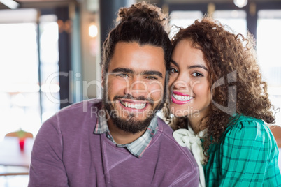 Portrait of cheerful young couple at restaurant