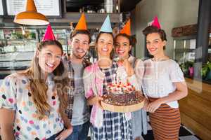 Cheerful friends celebrating birthday at restaurant