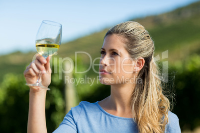 Woman looking at wine in glass