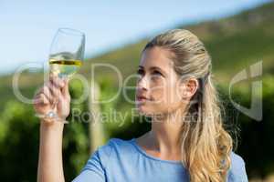 Woman looking at wine in glass