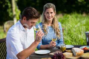 Smiling couple holding wineglasses at table