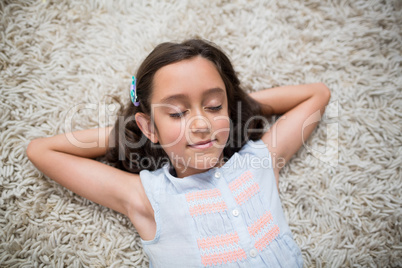 Girl sleeping on rug in living room