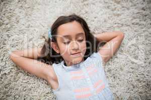 Girl sleeping on rug in living room