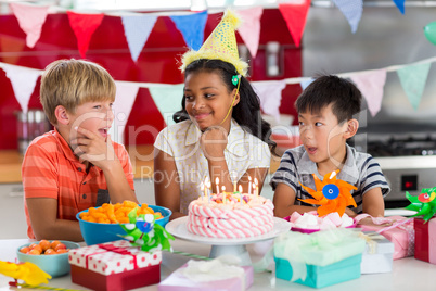 Siblings celebrating birthday in kitchen