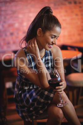 Young woman having red wine