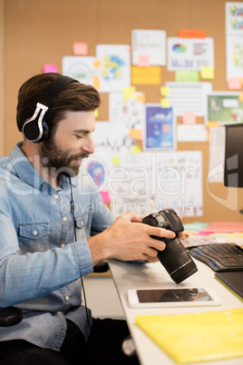 Photographer wearing headphones while using camera