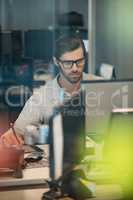 Concentrated businessman working on digitizer in office