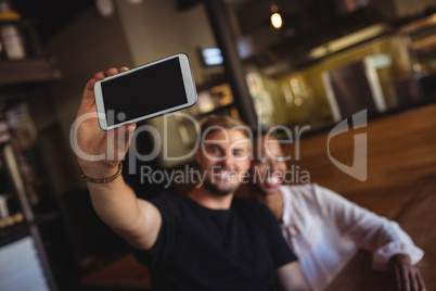 Happy couple taking selfie from mobile phone
