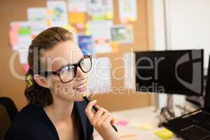 Thoughtful businesswoman looking away in office