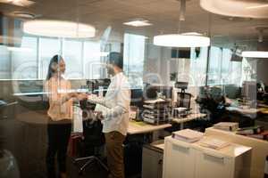 Business colleagues shaking hands in office