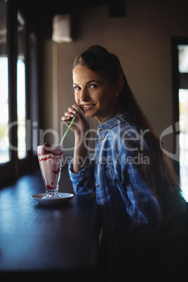 Portrait of beautiful woman having milkshake