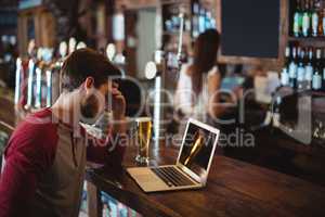 Upset man using laptop