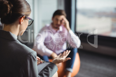 Counselor interacting with unhappy man