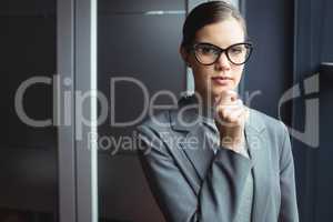 Counselor in glasses with hand on chin