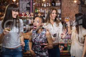Female friends dancing at pub