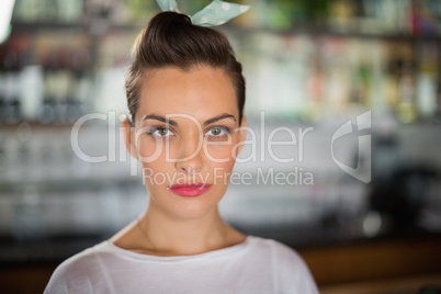 Portrait of serious young woman in cafe