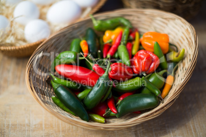 Bell peppers in wicker basket on table