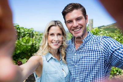 Portrait of smiling young couple at vineyard