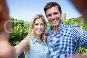 Portrait of smiling young couple at vineyard