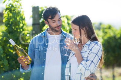 Man looking at girlfriend drinking wine