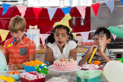 Siblings celebrating birthday in kitchen