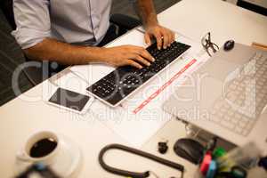 Mid section of businessman working in office