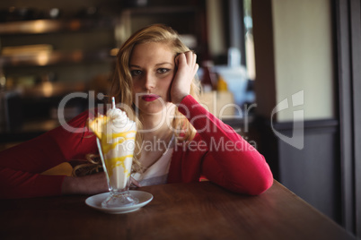 Portrait of beautiful woman having milkshake