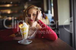 Portrait of beautiful woman having milkshake