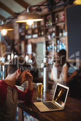 Upset man using laptop