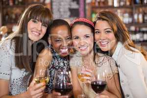 Portrait of happy female friends with wineglasses