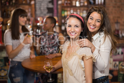 Portrait of smiling female friends in pub
