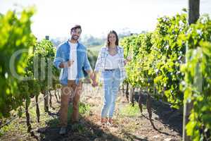 Portrait of couple with holding hands enjoying wine