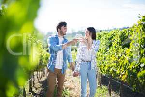 Couple with holding hands toasting wineglasses