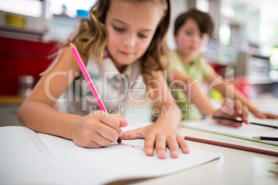 Siblings doing homework in kitchen