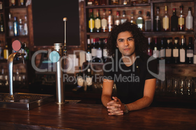 Male bar tender at bar counter