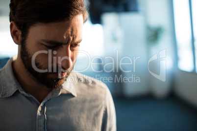 Upset businessman looking down