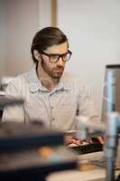 Businessman typing on computer keyboard at desk