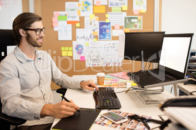 Businessman working on digitizer at creative office desk
