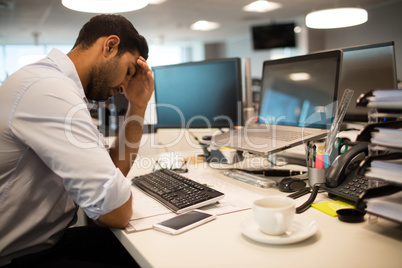 Restless businessman sitting in office