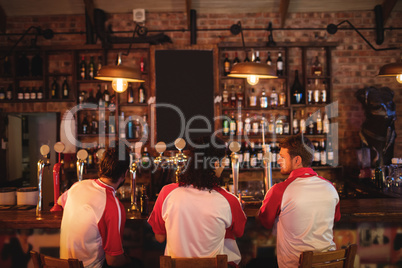 Group of male friends sitting at counter