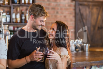 Smiling couple holding drinks