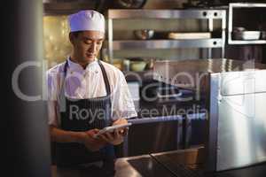 Chef using digital tablet in the commercial kitchen