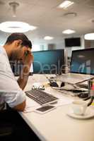 Tensed businessman sitting in office